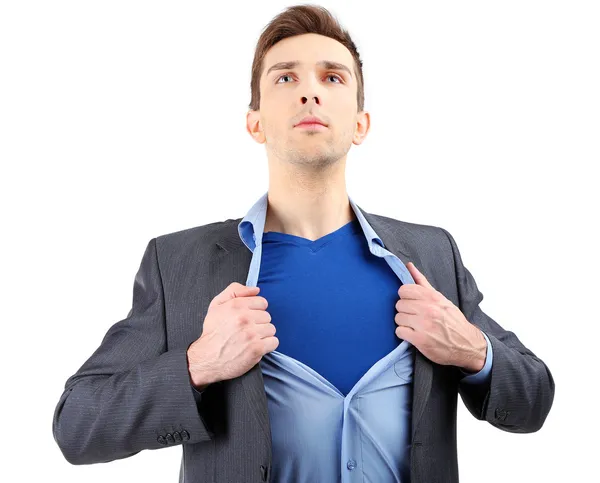 Jovem homem de negócios rasgando sua camisa revelando terno de super-herói, isolado em branco — Fotografia de Stock