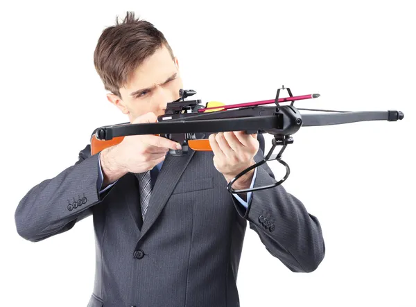 Young businessman with crossbow, isolated on white — Stock Photo, Image