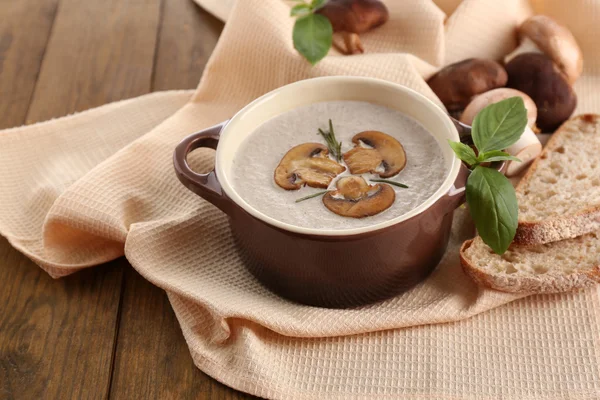 Mushroom soup in pot, on wooden background — Stock Photo, Image