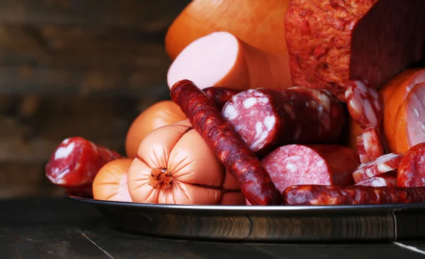 Lot of different sausages on salver close-up — Stock Photo, Image