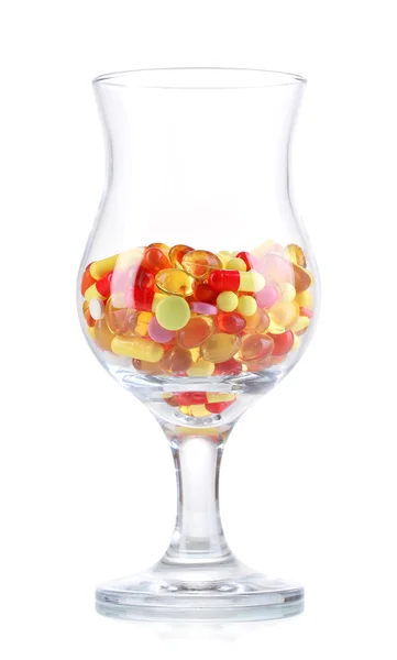 Goblet med piller isoleret på hvid - Stock-foto