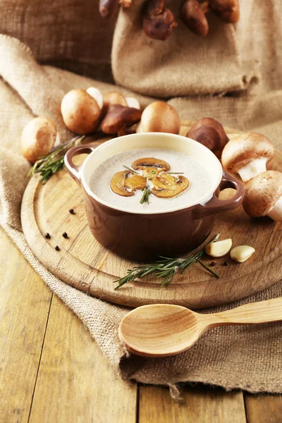 Composition with mushroom soup in pot, fresh and dried mushrooms, on wooden table, on sackcloth background — Stock Image Composition with mushroom soup in pot, fresh and dried mushrooms, on wooden table, on sackcloth background Royalty Free Stock Photos