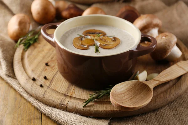 Composition with mushroom soup in pot, fresh and dried mushrooms, on wooden table, on sackcloth background — Stock Image Composition with mushroom soup in pot, fresh and dried mushrooms, on wooden table, on sackcloth background Royalty Free Stock Images