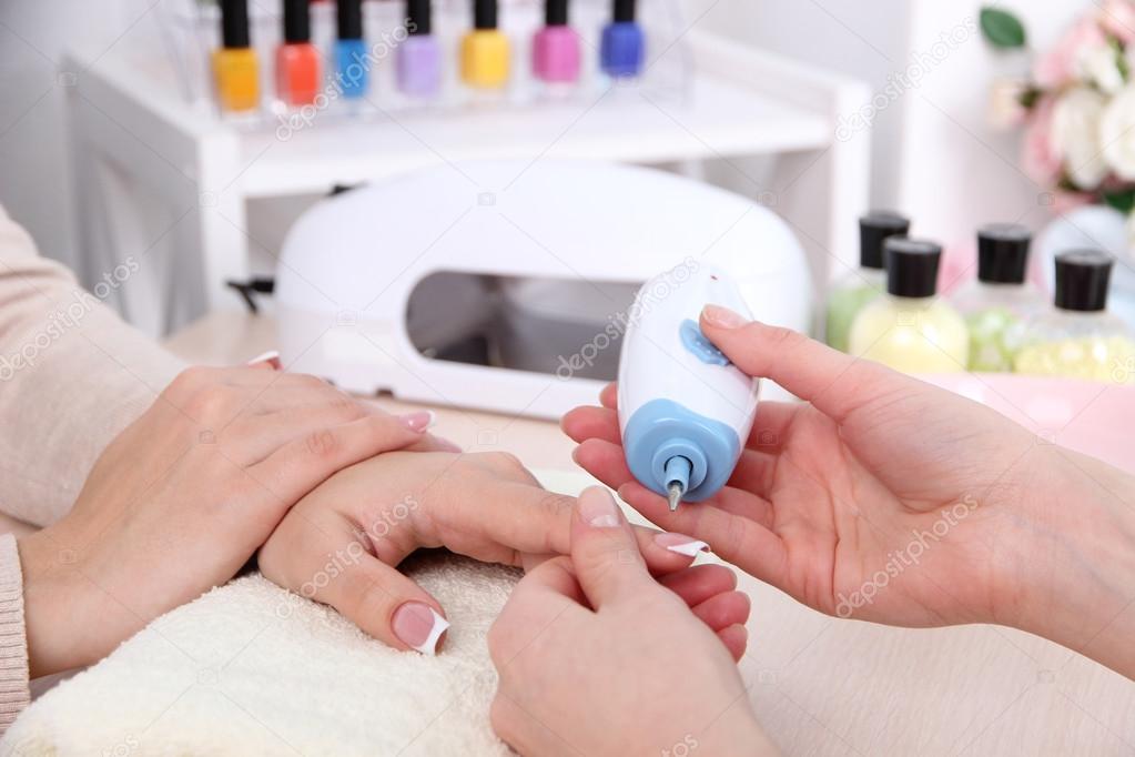 Manicure process in beauty salon close up