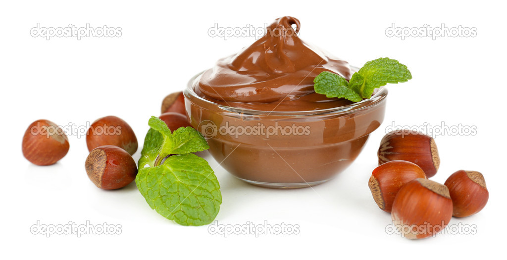 Sweet chocolate hazelnut spread with whole nuts and mint isolated on white