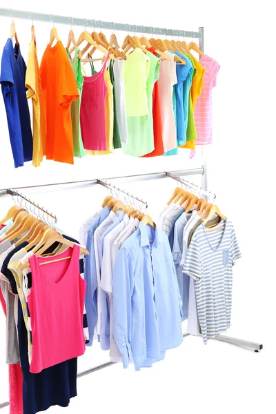 Verschillende kleding op hangers, op grijze achtergrond — Stockfoto