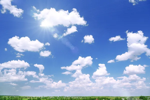 Blue sky with clouds and sun — Stock Photo, Image