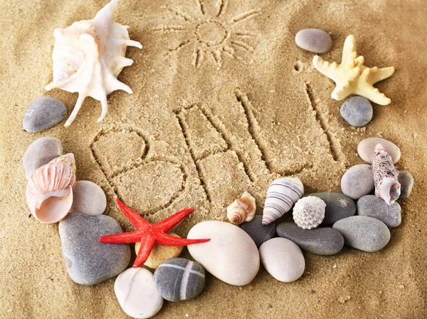 Inscription Bali on wet sand close-up background — Stock Photo, Image