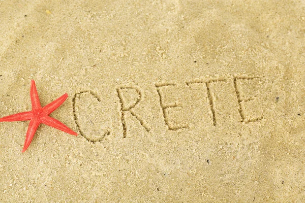 Inscription Crete in wet sand close-up background — Stock Photo, Image