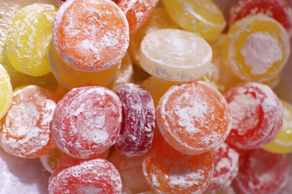 Sweet multicolor candies on paper, close up — Stock Photo, Image