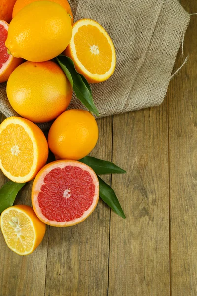 Lots ripe citrus on wooden background — Stock Photo, Image