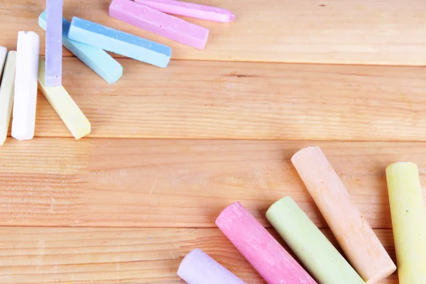 Chalks in variety of colors, on wooden background — Stock Photo, Image