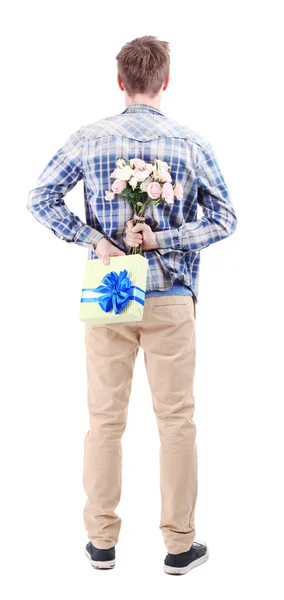 Handsome young man with flowers and gift, isolated on white — Stock Photo, Image