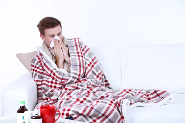 Guy wrapped in plaid sitting on sofa is ill — Stock Photo, Image