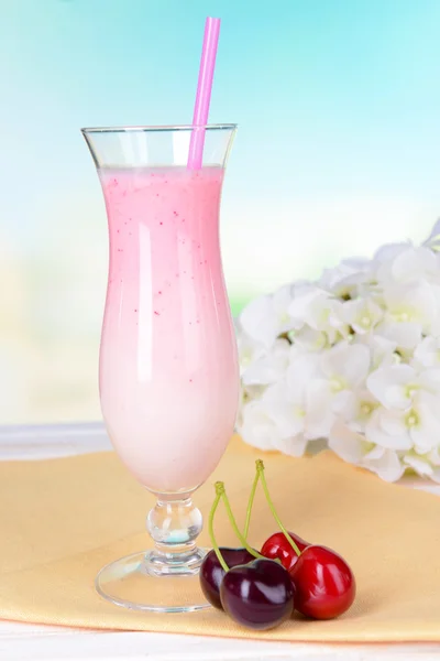 Milk shake on table on light blue background — Stock Photo, Image