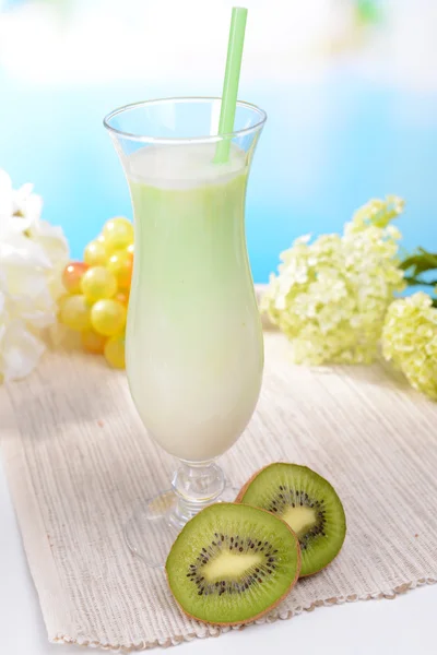 Milk shake on table on light blue background — Stock Photo, Image