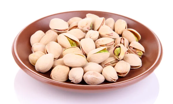Pistachio nuts on plate isolated on white — Stock Photo, Image