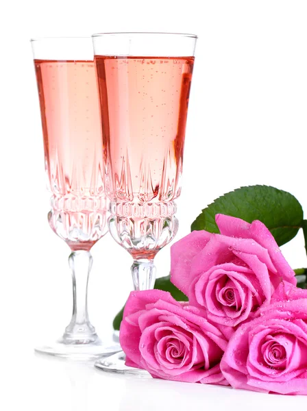 Composition with pink sparkle wine in glasses and pink roses isolated on white — Stock Photo, Image