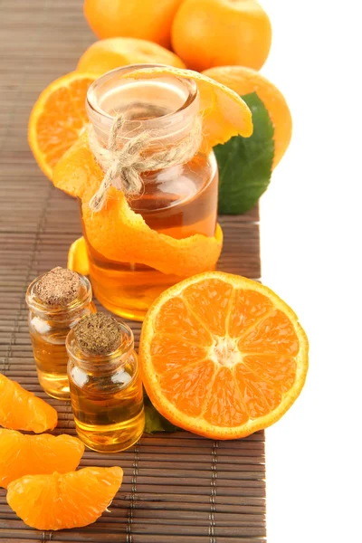 Tangerine essential oil and tangerines, isolated on white — Stock Photo, Image