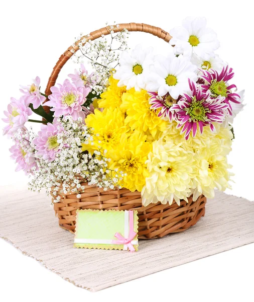 Beautiful chrysanthemum flowers in wicker basket isolated on white — Stock Photo, Image
