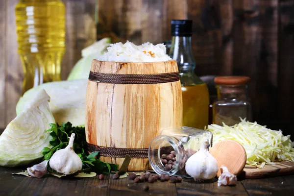 Composition with fresh and marinated cabbage (sauerkraut) in wooden barrel, on wooden table background — Stock Image Composition with fresh and marinated cabbage (sauerkraut) in wooden barrel, on wooden table background Stock Image