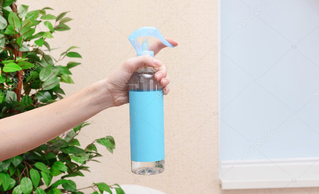 Sprayed air freshener in hand closeup — Stock Photo © belchonock 40816043