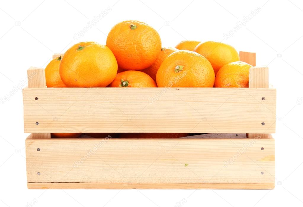 Ripe sweet tangerines in wooden box, isolated on white