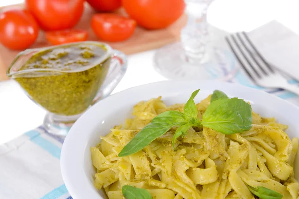 Massa deliciosa com pesto no prato na mesa close-up — Fotografia de Stock