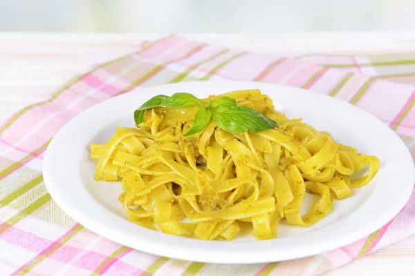 Delicious pasta with pesto on plate on table close-up — Stock Photo, Image