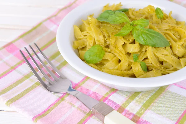 Delicious pasta with pesto on plate on table close-up — Stock Photo, Image