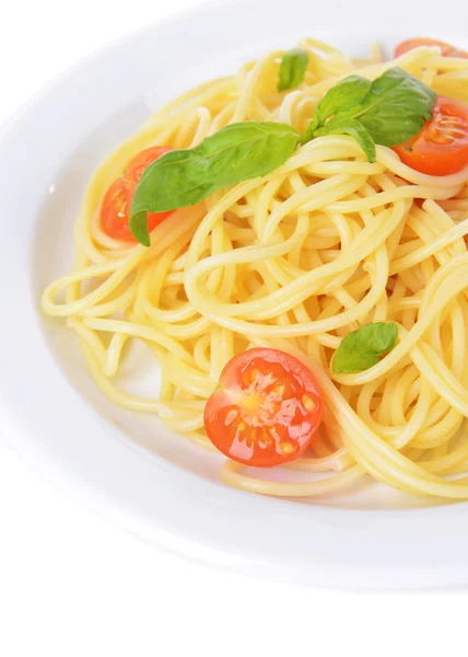 Delicious spaghetti with tomatoes on plate close-up — Stock Photo, Image