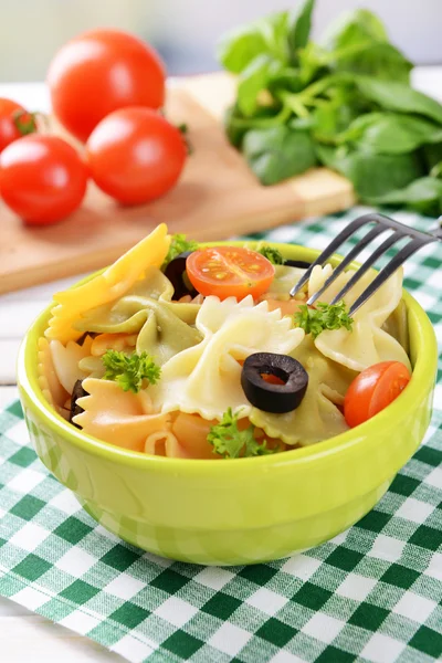 Delicious pasta with tomatoes on plate on table close-up — Stock Photo, Image