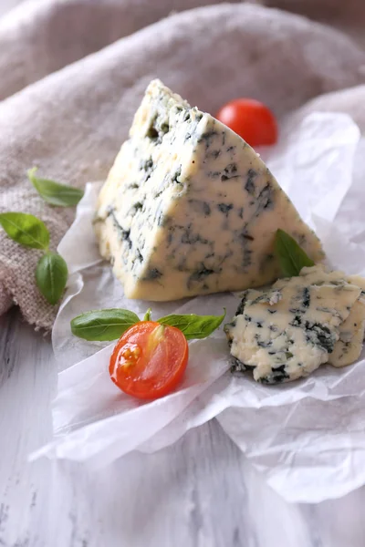 Chutné modrý sýr s rajčaty a bazalkou na papíře — Stock fotografie