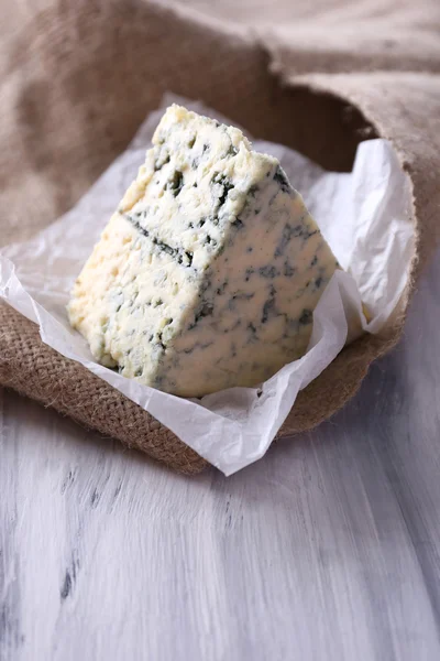 Smakelijke blauwe kaas, op houten tafel — Stockfoto