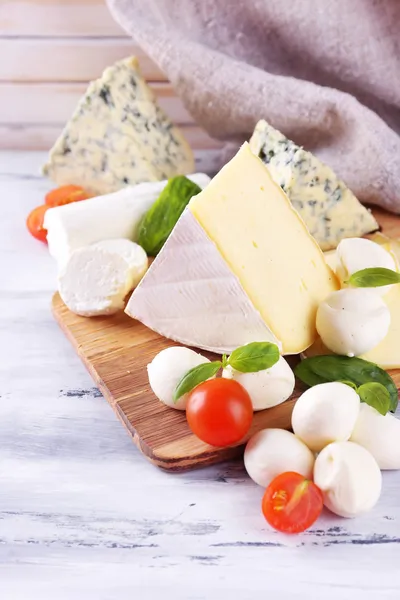 Different tasty cheese, on wooden table — Stock Photo, Image