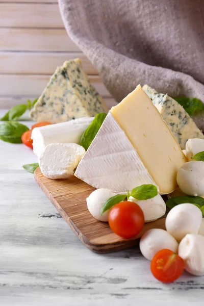 Different tasty cheese, on wooden table — Stock Photo, Image