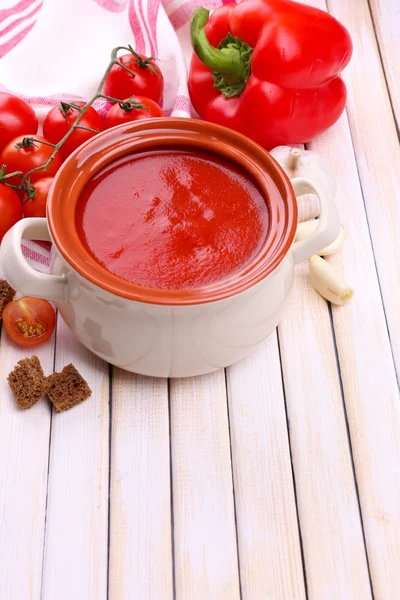 Tasty tomato soup and vegetables on wooden table — Stock Photo, Image