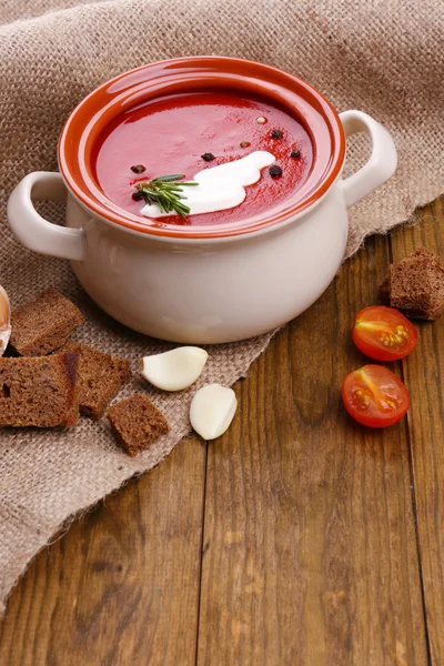 Tasty tomato soup on wooden table — Stock Photo, Image