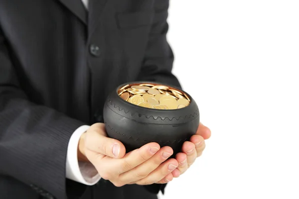 Ceramic pot with golden coins in male hands, isolated on white background — Stock Photo, Image