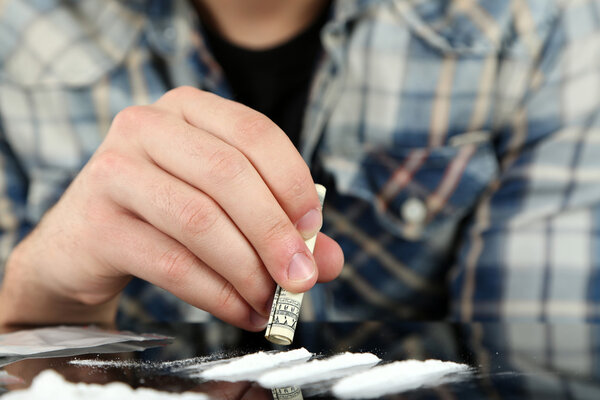 Man snorting cocaine, close up