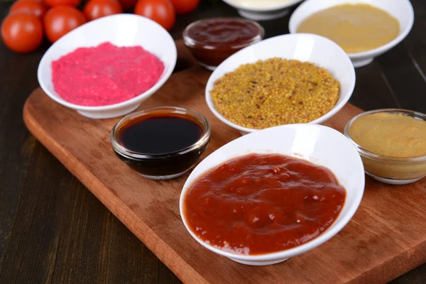 Varias salsas en la tabla de cortar en primer plano de la mesa — Foto de Stock