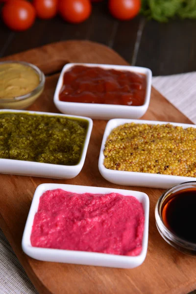 Various sauces on chopping board on table close-up — Stock Photo, Image