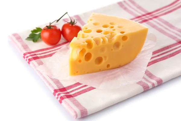 Piece of cheese and tomatoes,on color napkin, isolated on white — Stock Photo, Image