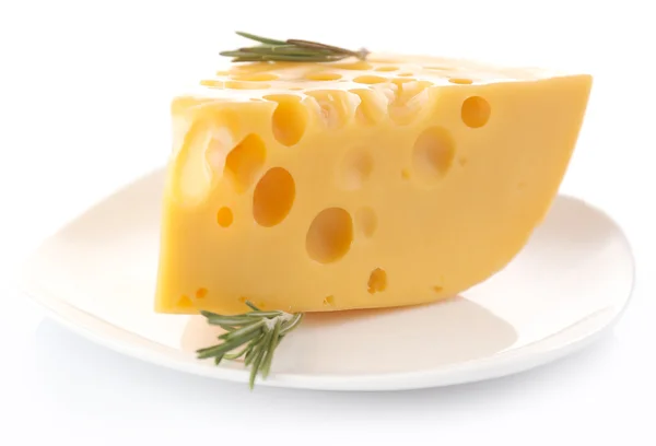 Piece of cheese with rosemary on plate, isolated on white — Stock Photo, Image