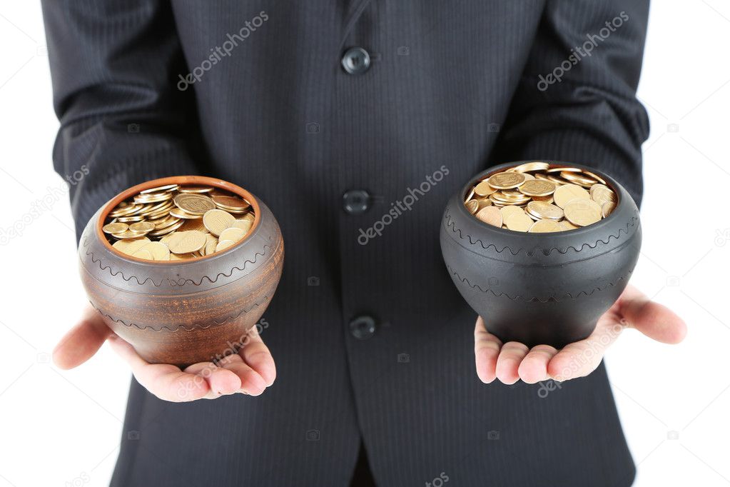 Two ceramic pots with golden coins in male hands, isolated on white background