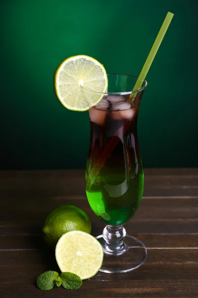 Vaso de cóctel sobre mesa sobre fondo verde oscuro — Foto de Stock