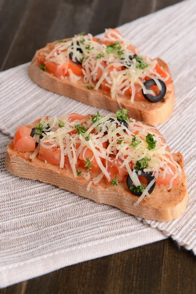 Delicious bruschetta with tomatoes on table close-up — Stock Photo, Image