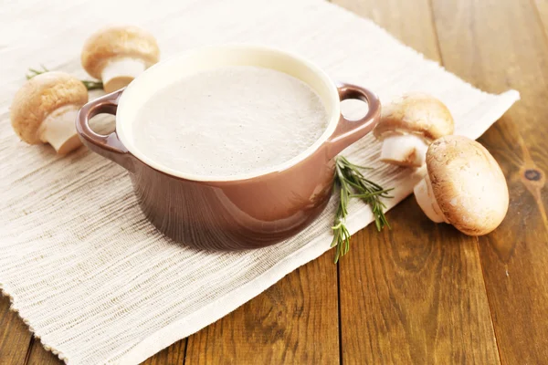 Mushroom soup in pot, on wooden background — Stock Photo, Image