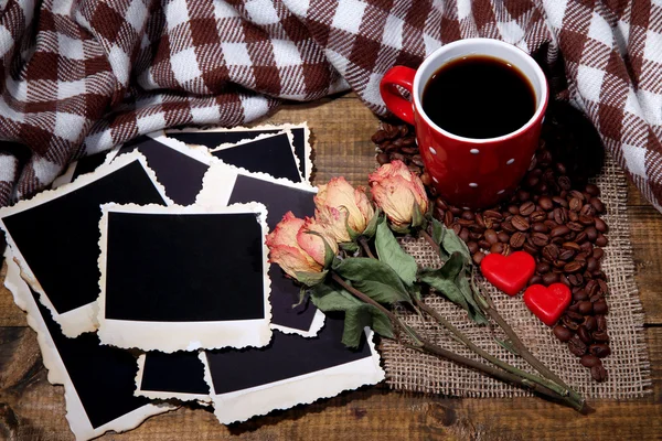 Composition with coffee cup, decorative hearts, plaid spices and old blank photos, on wooden background — Stock Photo, Image