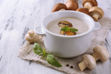 peçeteye ahşap arka plan üzerinde beyaz tencerede mantar çorbası